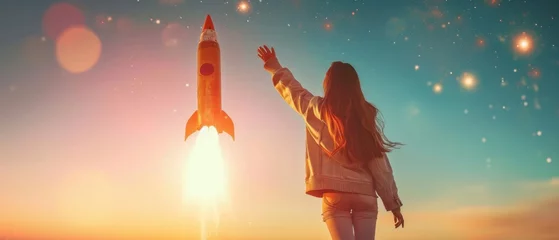 Foto op Canvas A Girl Reaching For A Rocket. Сoncept Rocket Launch, Space Exploration, Dreaming Big, Ambitious Goals, Girl Power © Ян Заболотний