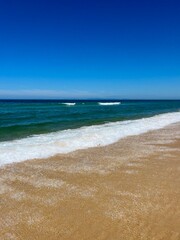Blue seascape, sandy sea coastline, empty wild beach, pure blue sky, sea horizon