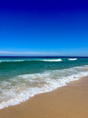 Blue seascape, sandy sea coastline, empty wild beach, pure blue sky, sea horizon