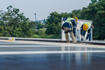 Worker Technicians are working to construct solar panels system on roof. Installing solar...