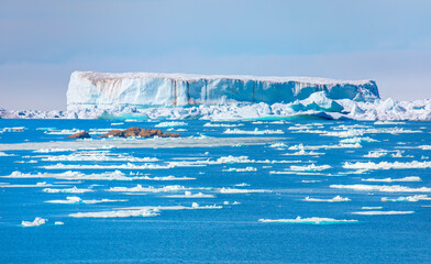 Melting icebergs by the coast of Greenland, on a beautiful summer day - Melting of a iceberg and...