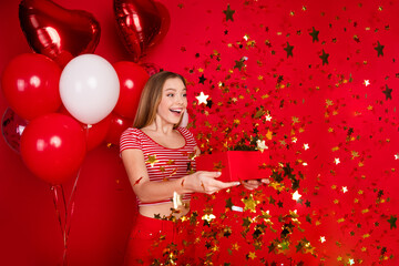 Photo of impressed funky girl wear striped top getting birthday presents enjoying surprise party isolated red color background