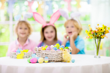 Obraz na płótnie Canvas Kids on Easter egg hunt. Children dye eggs.