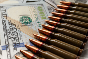Bullets lie on American dollar bills, arms trade