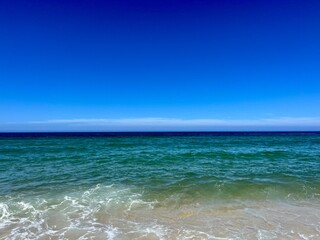 Fototapeta na wymiar Pure blue sea horizon, blue seascape background, clear sky