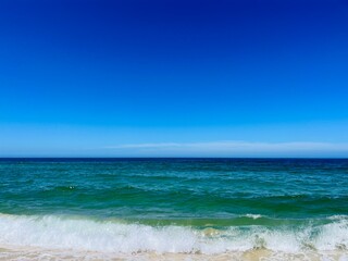 Fototapeta na wymiar Pure blue sea horizon, blue seascape background, clear sky