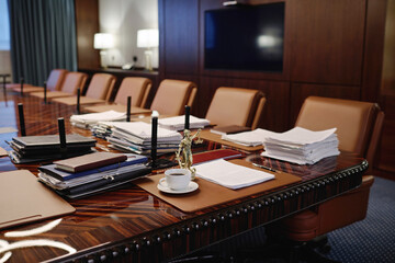 Interior of spacious conference room with modern furniture and statue of goddess of justice on table