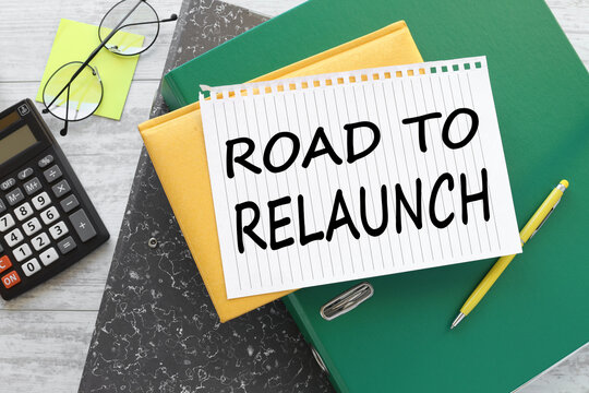 Road To Relaunch Integration text on a notebook on a green folder