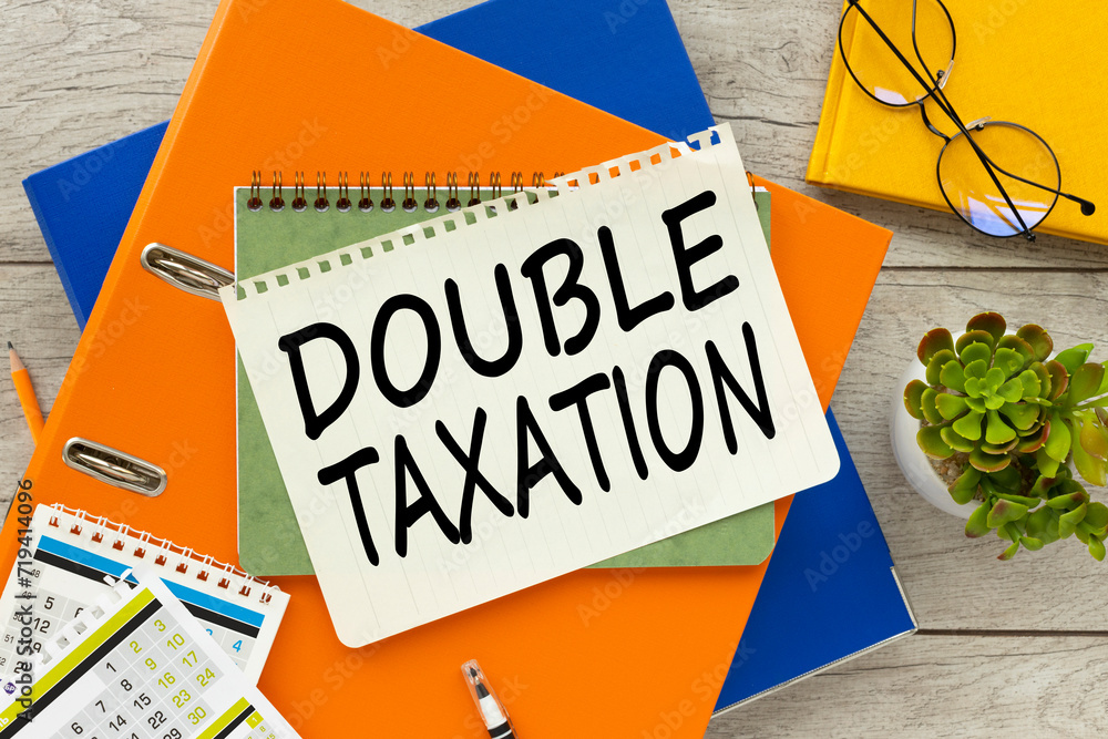 Poster double taxation two folders on the desktop. text on the page. notepad on folder
