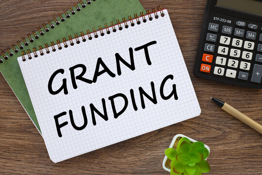Grant funding symbol. Beautiful wooden table. Business financing and grants concept. Copy space.