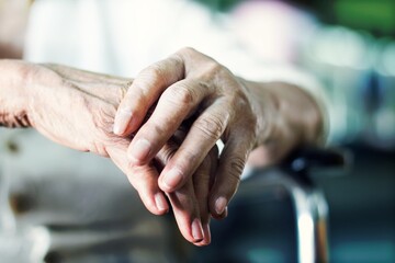 Close up hands of senior elderly woman patient suffering from pakinson's desease symptom. Mental health and elderly care concept