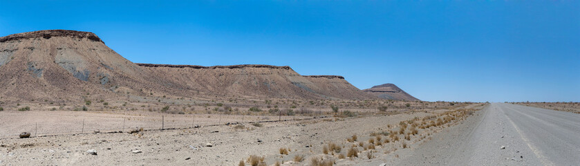 C12 gravel road and conglomerate and basalt slopes on desert escarpment, south of Sesriem,  Namibia