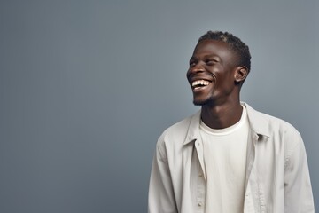 Fototapeta premium A man wearing a white shirt can be seen in the photo, laughing joyfully.