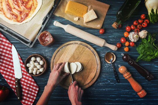 cropped image woman cutting mozzarella