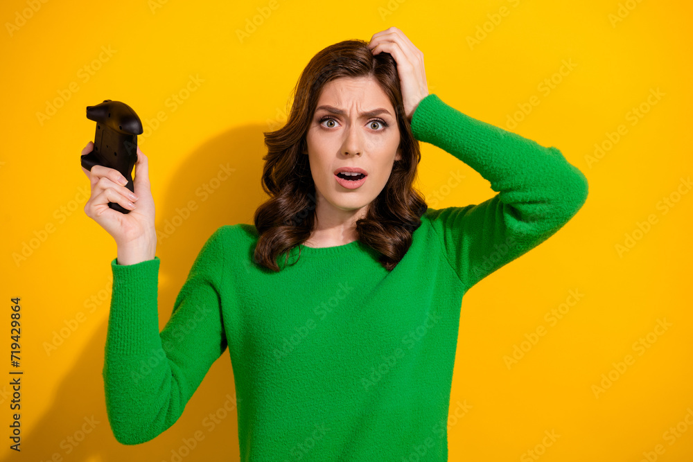 Poster Photo of upset woman addicted gamer wear trendy green clothes failed game over isolated on yellow color background