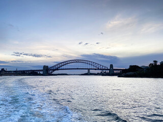Fototapeta premium Sydney Harbour bridge at night. City harbour bridge silhouette at sunset. Largest steel arch bridge from the ocean at nightfall, Australia.