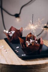 Chocolate muffins with sparklers.