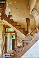 Ornate Abandoned Staircase with Graffiti in Dilapidated Building