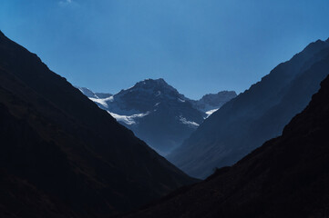 mountain peaks of glaciers with snow on the background of a blue