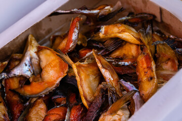 Sale of smoked fish pieces for snacks. Fish trade at street fairs