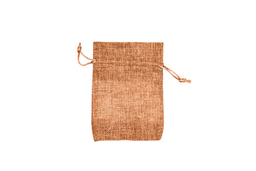 One empty peach fuzz colored cotton fabric bag (beige burlap pouch). Copy space for text. Selective focus.