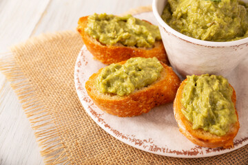 Smashed avocado toast breakfast. Mashed avocado toasts. Healthy eating, dieting, tasty vegan vegetarian food. Served on white plate. Easy recipe for healthy homemade breakfast.