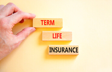 Term life insurance symbol. Concept words Term life insurance on beautiful wooden blocks. Beautiful white table white background. Doctor hand. Medical term life insurance concept. Copy space.