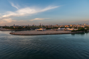 Fototapeta premium Perspective of skyscraper towers and bay cityscape skyline of Abu Dhabi, sunrise in UAE.