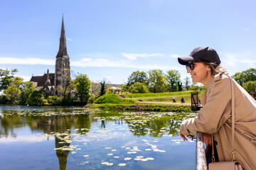 Portrait young beautiful happy smiling womane wear biege trench coat enjoy walking Kastellet...