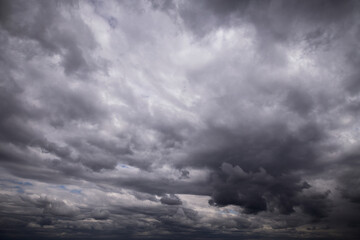 Epic dramatic Storm sky with dark grey and black cumulus rainy clouds background texture, thunderstorm