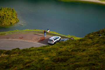 Tourists taking photos and admiring the magnificent landscape of Lagoa do Fogo, Sao Miguel island...