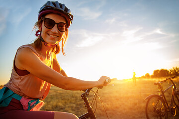 Portrait of young adult fit sporty smiling caucasian woman enjoy riding cross country bike on hay...