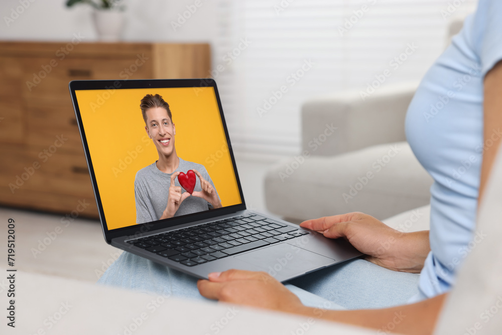 Poster Long distance love. Woman having video chat with her boyfriend via laptop at home, closeup