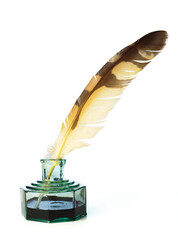 Quill pen with a glass bottle of ink. Feather in an inkwell.