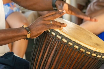Man's hands playing African drum 