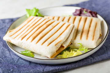 rolled tortillas grilled on white plate - 719538693