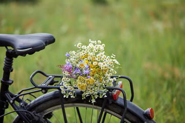 Beautiful bouquet of wild flowers on a mountain bike