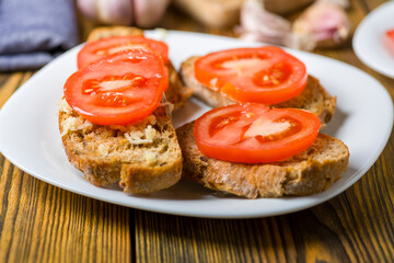 toast in olive oil spread with garlic and  tomato