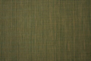 Hessian burlap woven texture background in yellow-green color. Selective focus. Copyspace.