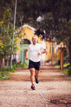 Mature man running, workout and streetching at the city park