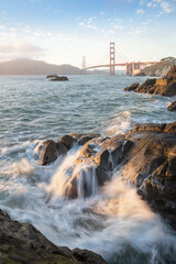 Golden Gate Bridge during sunset with crashing waves, new San Fransisco, California, USA
The Golden Gate Bridge is the most famous attraction.
Traveling concept background.