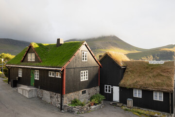 Fototapeta na wymiar Houses with turf roofs, Bour village, vagar island, faroe islands, denmark, europe Sunny summer view of Saksun village with typical turf-top houses. Traveling concept background.