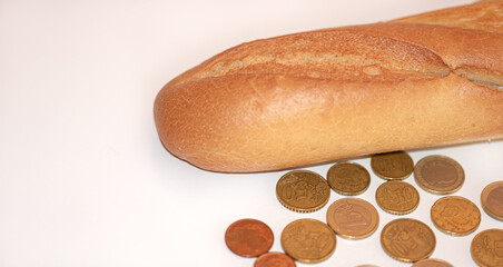 loaf of bread and money coins with white background and copy space