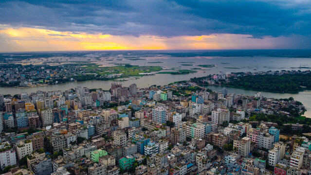 Aerial urban Sunset in a dense city by the water . Dhaka is the capital of Bangladesh and one of the most populated city in the World.