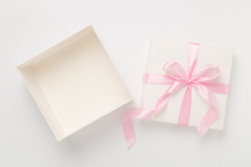 White open gift box on color background, top view. Mock up for design