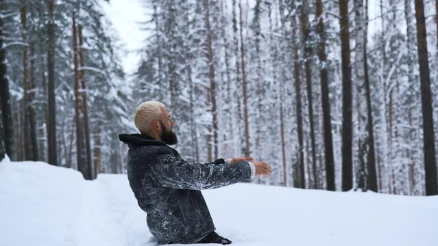 Man begs for help. Media. Lost man prays to God for help in winter forest. Man got lost in forest alone and begs for help on winter day
