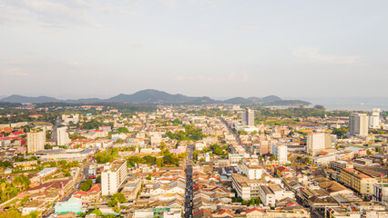 Fototapeta premium Aerial view, drone flying over Phuket city, Thailand. Drone over SinoPortugyese It's a Sunday in Phuket and tourists go shopping on the old streets filled with local merchants selling food and clothes