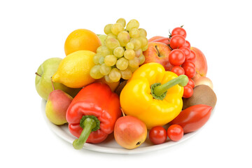 Fruits and vegetables on a plate isolated on white.