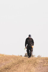 Metal search. A man holds a metal detector in his hand. Search for treasures. Search for antique coins.