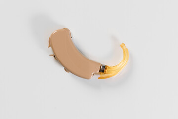 hearing aid on white background in hand, cochlear implant